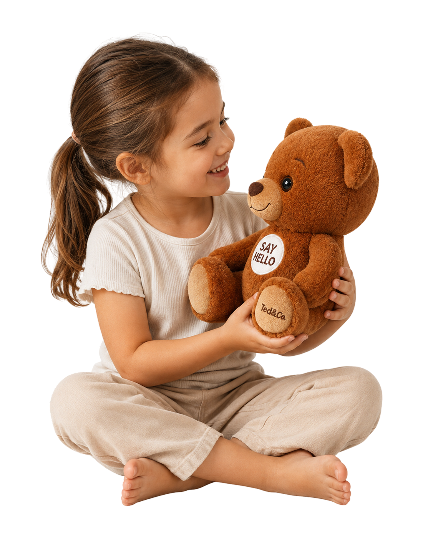 A young girl sitting on the floor, smiling at her Ted teddy bear