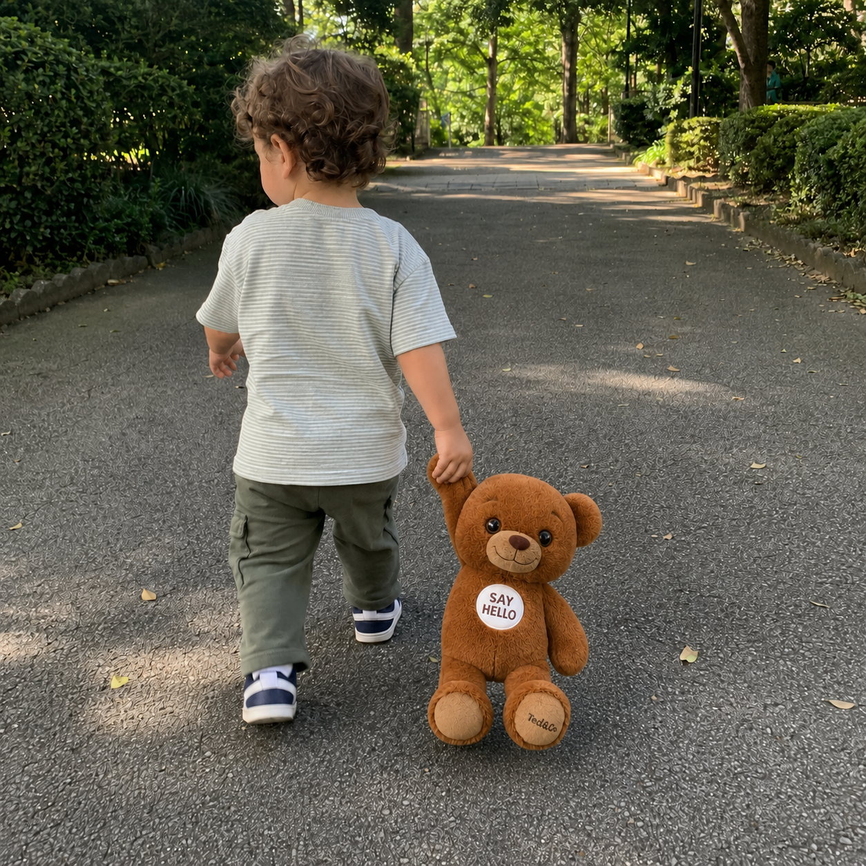 Child dragging Ted by one paw outdoors